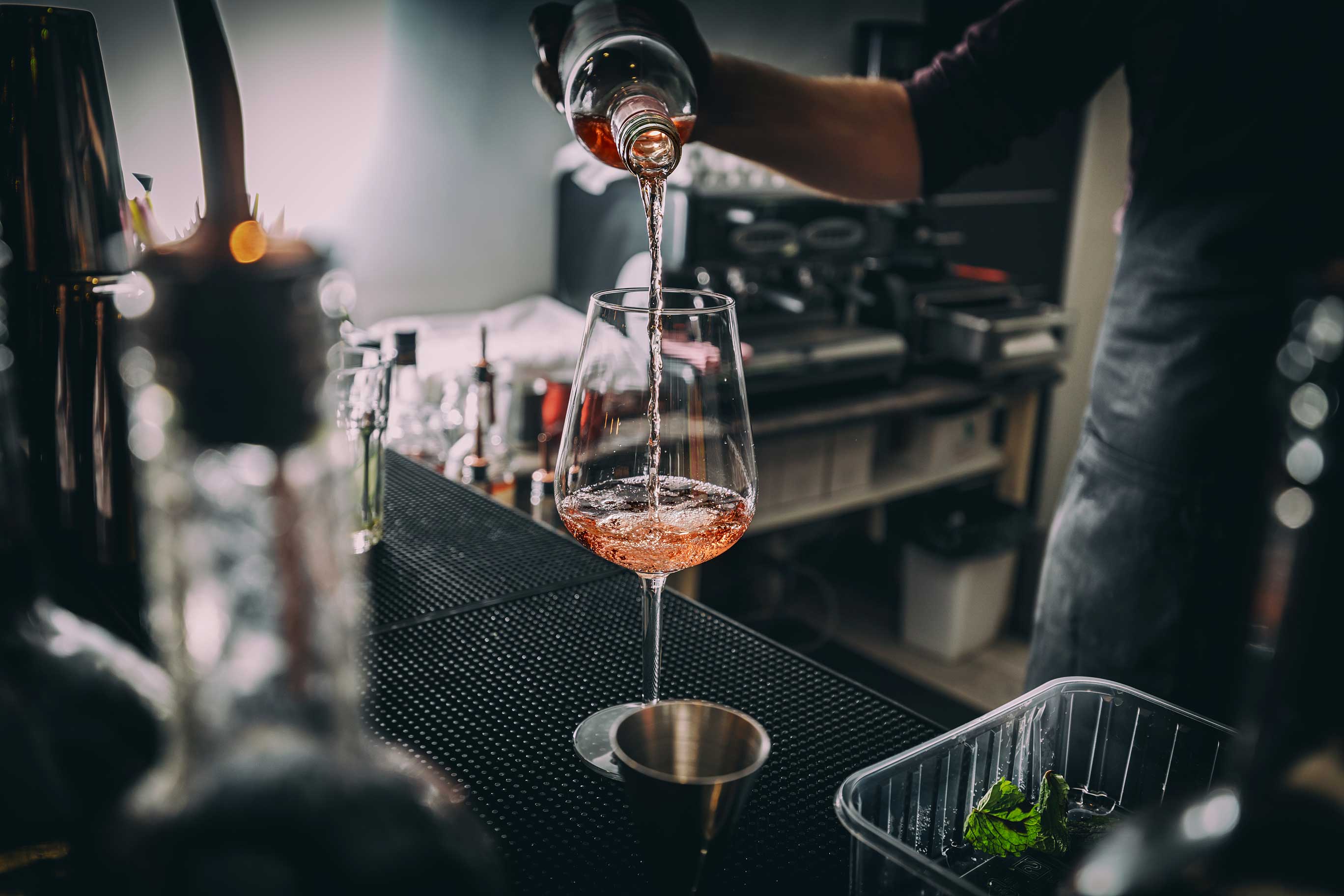 close up of a bartender pouring wine